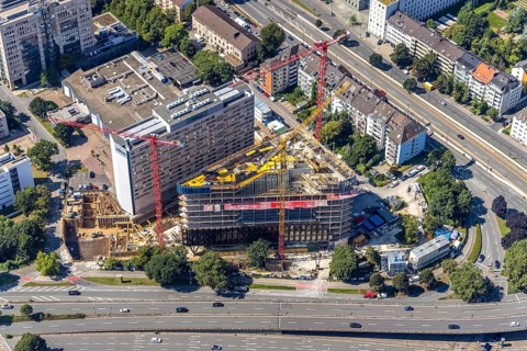 Aerial view, construction site and new construction of the three-storey Eclipse high-rise building