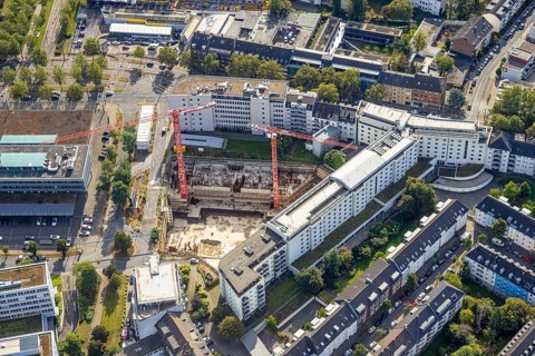 Aerial view, construction site on Mercedesstraße with new construction of an office and residential