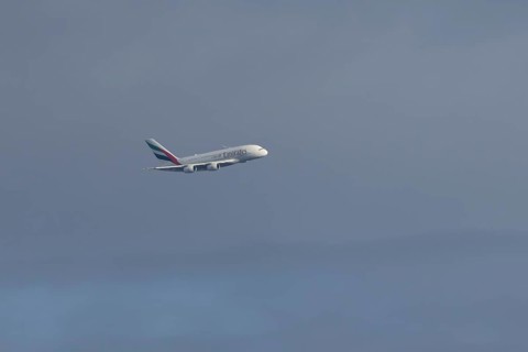 Airbus A380 jet passenger aircraft of Emirates airlines flying in a blue sky, England, United