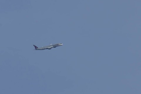 Airbus A350 jet passenger aircraft of Qater airlines flying in a blue sky, England, United Kingdom