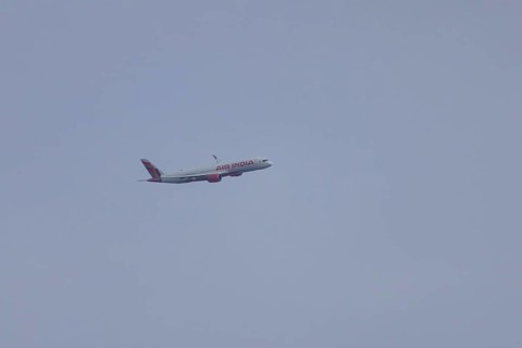 Aircraft of Air India airways in flight in a blue sky, London, England, United Kingdom