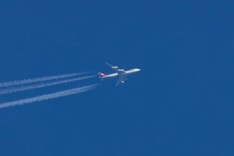 Boeing 747 Jumbo jet cargo aircraft of Cargolux airlines in flight in a blue sky with vapour trails