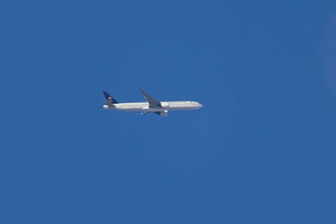 Boeing 777 jet passenger aircraft of Saudi airlines in flight in a blue sky, England, United
