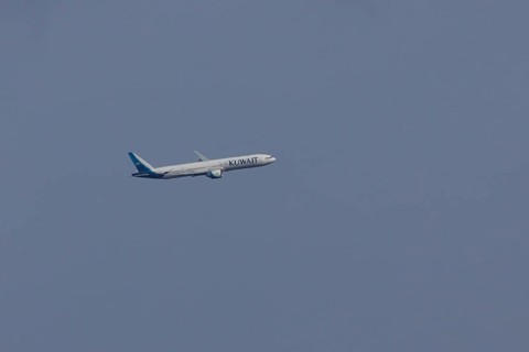 Boeing 777 jet passenger aircraft of Kuwait airlines in flight in a blue sky, England, United