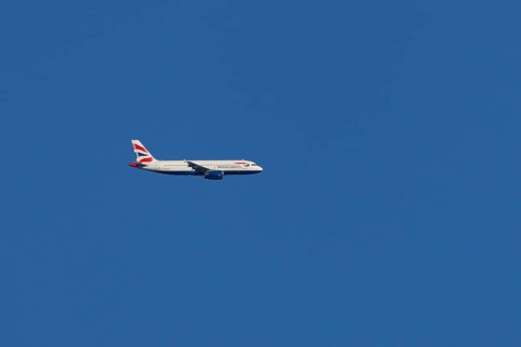 Airbus A320-232 jet passenger aircraft of British Airways airlines in flight in a blue sky, London,
