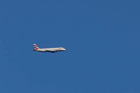 Airbus A320-232 jet passenger aircraft of British Airways airlines in flight in a blue sky, London,