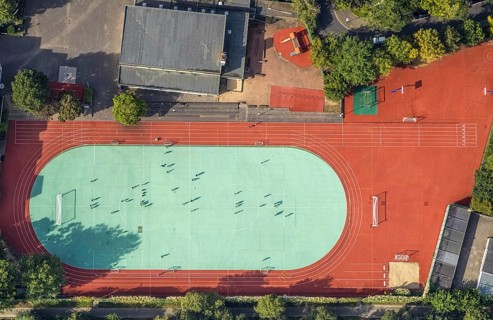 Aerial view, sports activities on the sports field at the Japanese International School in the