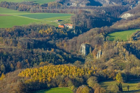 Aerial view, Reckenhöhle dripstone cave in the autumnal forest in the district Volkringhausen in