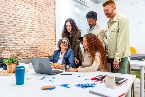 Diverse business professionals sharing ideas and laughing together during a collaborative podcast