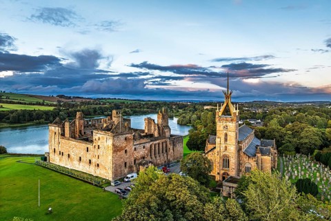 Sunset over Linlithgow Palace from a drone, Linlithgow Loch, West Lothian, Scotland, United Kingdom