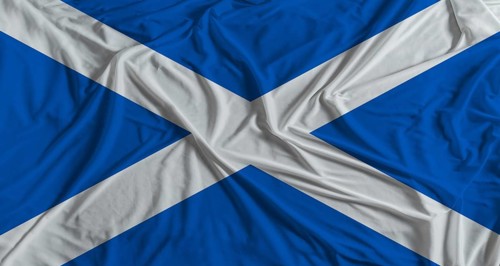 Scottish flag with fabric texture background. National flag of Scotland