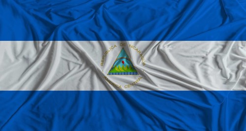 Nicaraguan flag with fabric texture background. National flag of Nicaragua
