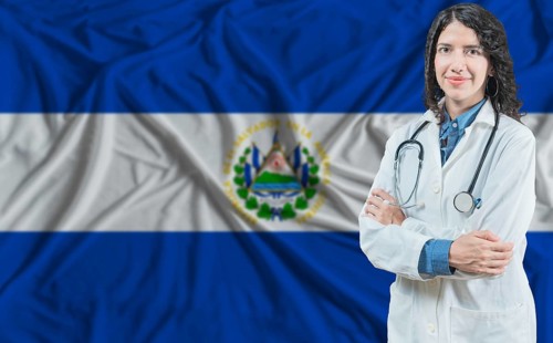 Salvadoran medicine and healthcare concept. Doctor close up against El Salvador flag background