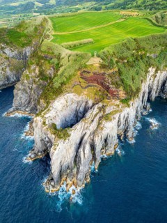 Cape Furado, Rocky Cliffs, Green Lush Fields, Pasturelands and Atlantic Ocean. Azores, Sao Miguel