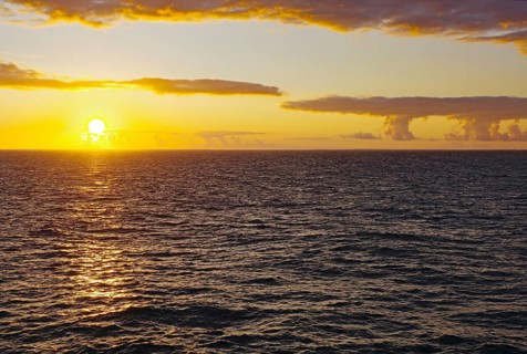 Sunset over the sea with yellow reflections on the waves, Orkney Islands, Scotland, Great Britain