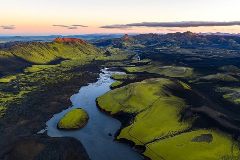 Moss-covered landscape with mountains and river in the Icelandic Highlands, Iceland