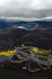 Blue crater lake in black sand desert, Icelandic Highlands, Iceland
