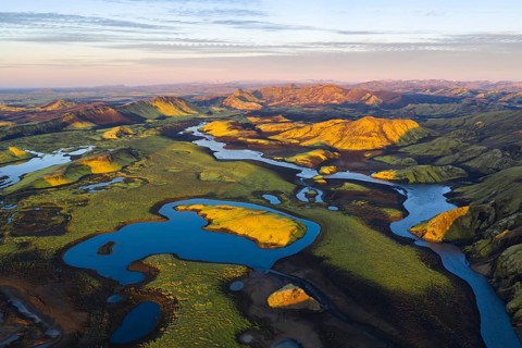 Mossy landscape and lakes at sunrise, Icelandic Highlands, Iceland