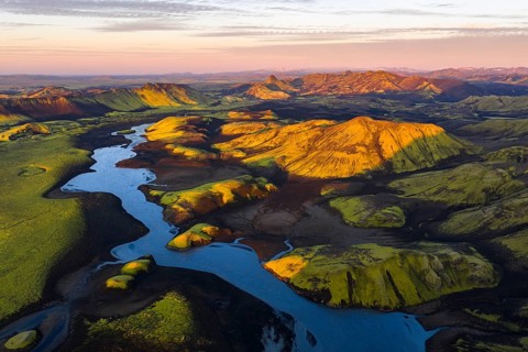 Mossy landscape with river and mountains at sunrise, Icelandic Highlands, Iceland