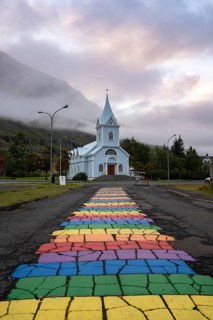 Church with rainbow pedestrian path in the town of Seyðisfjörður, East Iceland, Iceland