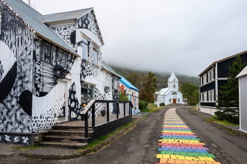 Church with rainbow pedestrian path in the town of Seyðisfjörður, East Iceland, Iceland