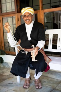 Indian man, 63 years old, from the Kodava clan in traditional dress showing a traditional dagger