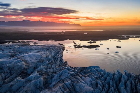 Glacier with Fjallsarlon glacier lagoon at sunrise, Vatnajökull National Park, South Iceland,