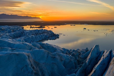 Glacier with Fjallsarlon glacier lagoon at sunrise, Vatnajökull National Park, South Iceland,