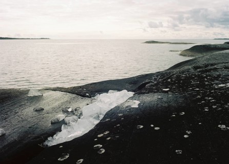 Ice remains from winter on the rocky shore of Lake Vänern, monochrome, analogue, Värmland, Sweden