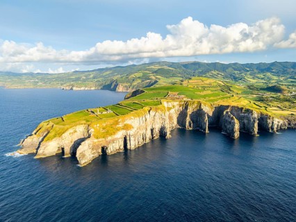 Cape Cintrao, Cliffs, Green Lush Hills, Fields, Pasturelands and Atlantic Ocean on Sunny Evening.