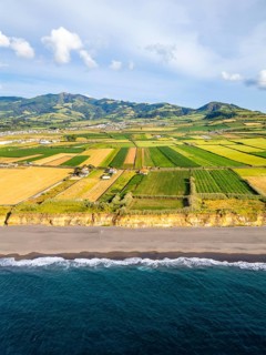 Santa Barbara Beach, Green Lush Fields with Pasturelands and Atlantic Ocean. Mountains on