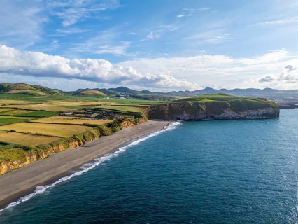 Areal de Santa Barbara Beach, Green Lush Fields and Atlantic Ocean on Sunny Day. Azores, Sao Miguel