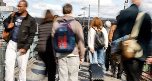 People walking across a bridge at Warschauer Straße station, Berlin, 02 October 2025, Berlin,