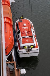 Lifeboat, cruise ship being lifted onto a cruise ship, Juneau, Alaska, USA