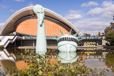 Symbolisation of a Statue of Liberty submerged in water in front of the Haus der Kulturen der Welt