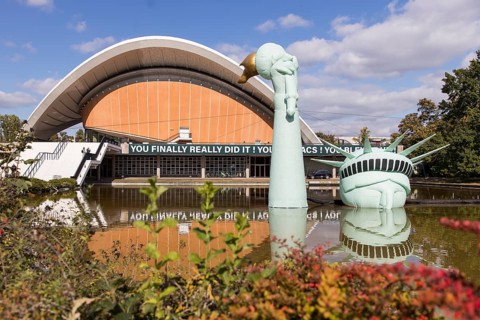 Symbolisation of a Statue of Liberty submerged in water in front of the Haus der Kulturen der Welt