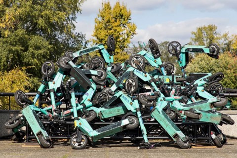 E-scooters stacked on top of each other are on display on the roof terrace of the Haus der Kulturen