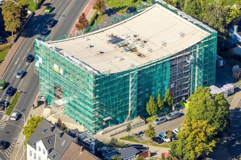 Aerial view, Hamm Municipal Music School, covered building and construction site with new building,