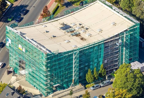 Aerial view, Hamm Municipal Music School, covered building and construction site with new building,