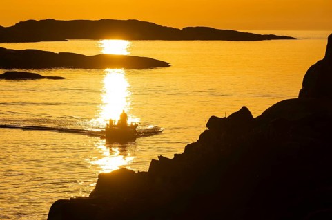 Motorboat between archipelago at sunset, archipelago landscape, Smögen, Smögenbryggan, Västra