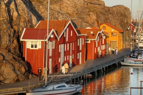 Colourful boathouses and boats in the harbour of Smögen, evening mood, Smögenbryggan, Västra