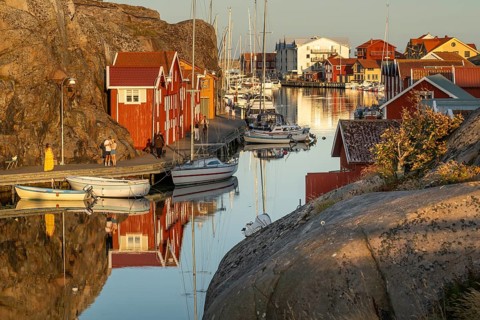 Colourful boathouses and boats in the harbour of Smögen, evening mood, Smögenbryggan, Västra