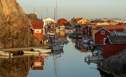 Colourful boathouses and boats in the harbour of Smögen, evening mood, Smögenbryggan, Västra