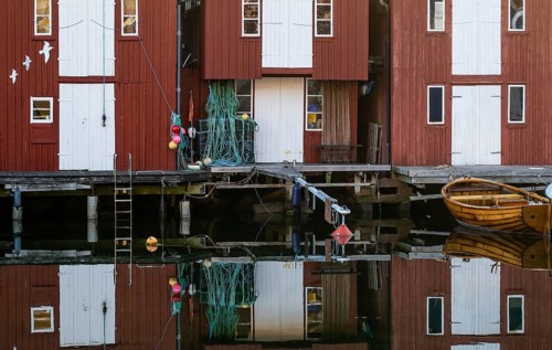 Boats and falun red boathouses in the harbour of Smögen, Smögenbryggan, Västra Götalands Län,