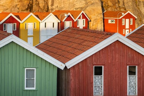Colourful boathouses between rocks in the harbour of Smögen, Smögenbryggan, Västra Götalands Län,
