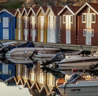 Boats and colourful boathouses in the harbour of Smögen, Smögenbryggan, Västra Götalands Län,