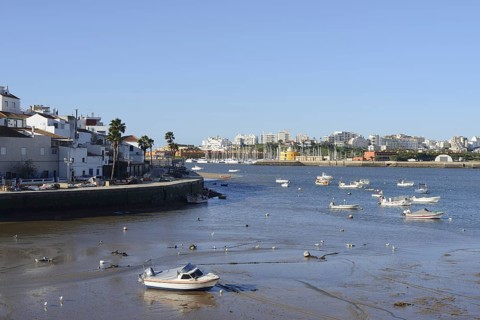 View over the mouth of the river Arade with fishing boats to Portimao, Ferragudo, Algarve, Portugal