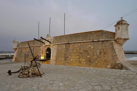 Forte da Ponta da Bandeira fortress at dusk, Lagos, Algarve, Portugal