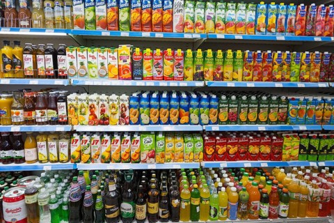 A shelf full of bottles of juices and other drinks in various flavours, Gntunik supermarket,
