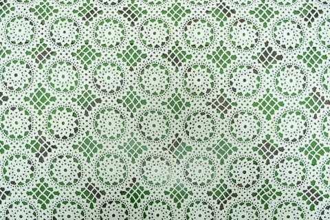 White floral fabric crocheted from cotton threads, textured background